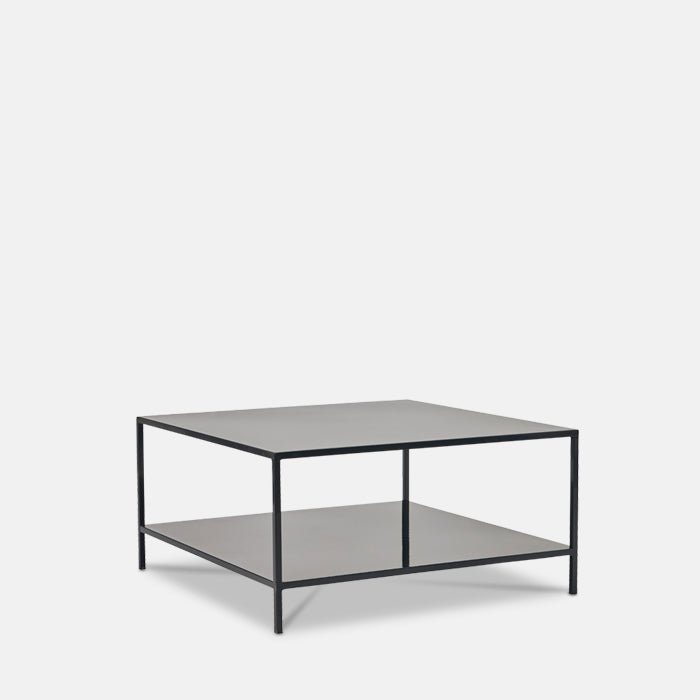 Square coffee table in black metal finish, with low storage shelf beneath table top.