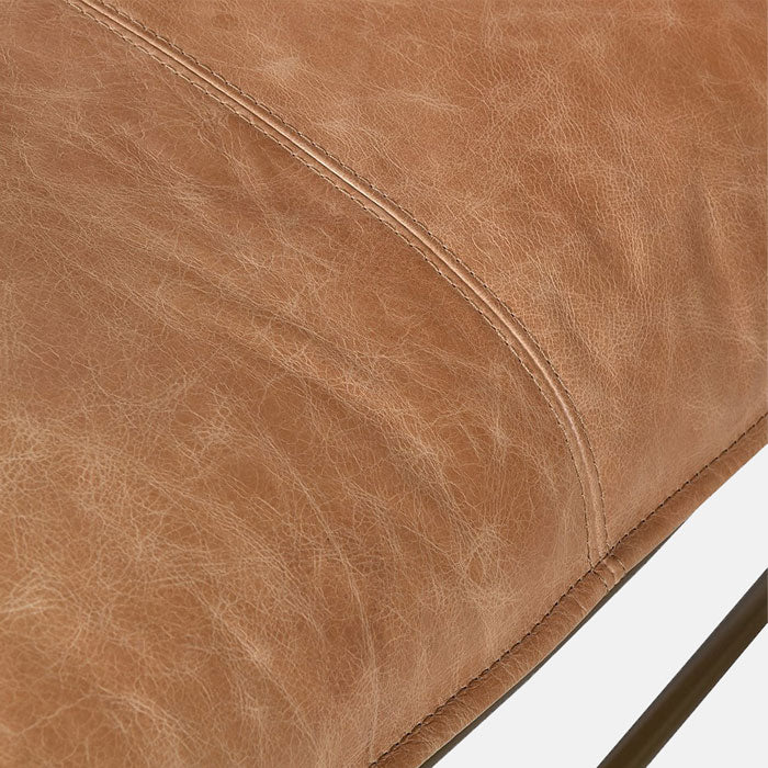 Soft brown leather cushioning on an armchair