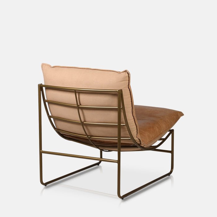 Gold metal frame and brown cushioning of a contemporary armchair