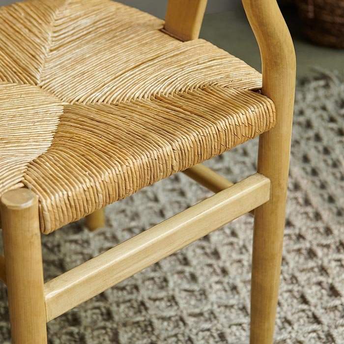 Woven straw seat on wooden dining chair.