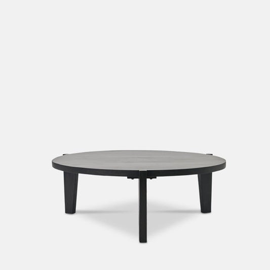 Round black wooden coffee table, with three legs.
