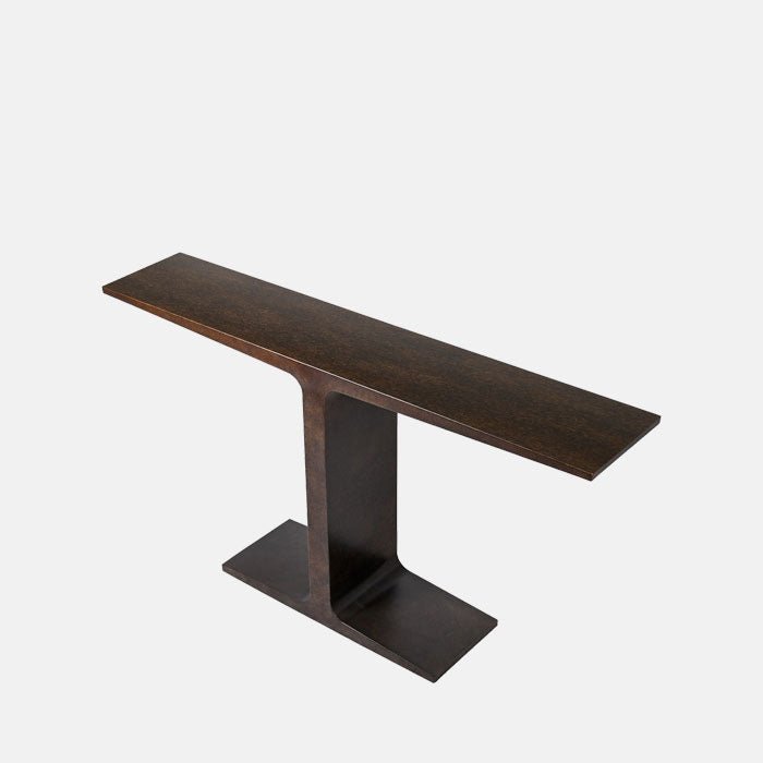 A cutout of the Harrow Console, with a sculptural t-shape in a burnished iron finish, shown from an angle.