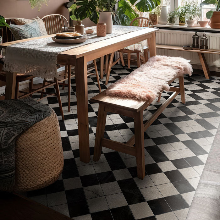 Large black and white tiled vinyl rug laid out underneath a wooden dining table and bench