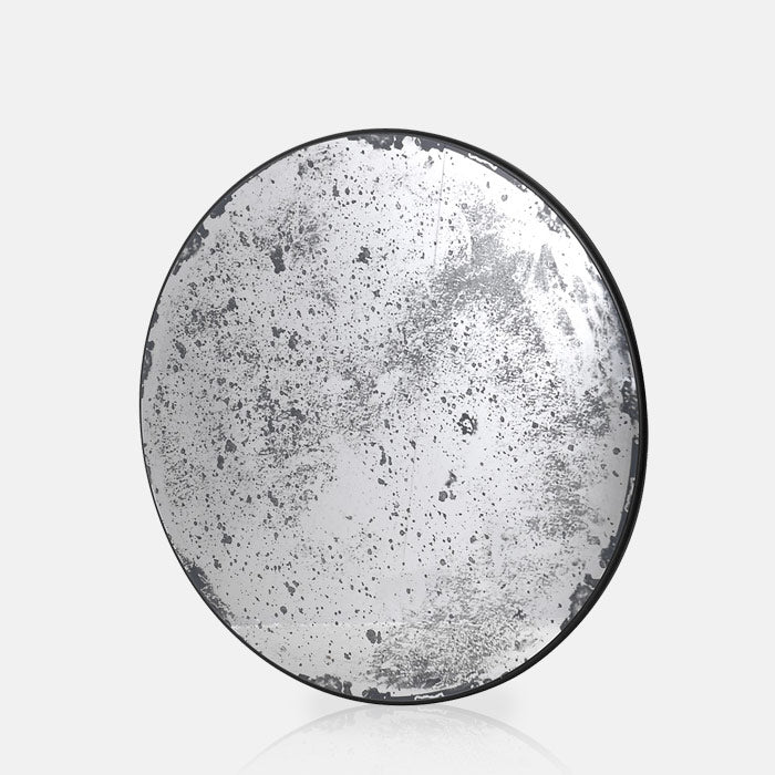 The Hyde Antiqued Mirror, a large round mirror with a sleek black frame, featuring antiqued glass.