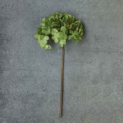 One artificial hydrangea flower with green petals and brown stem.
