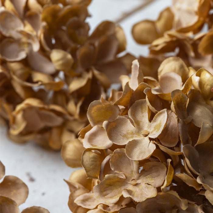 Up close image of soft brown and rust hued petals that make up the faux hydrangea stems. A stunning, natural toned addition to any room in your home.