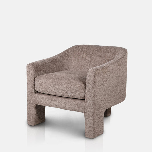 Armchair with cushion and three plinth-like legs.