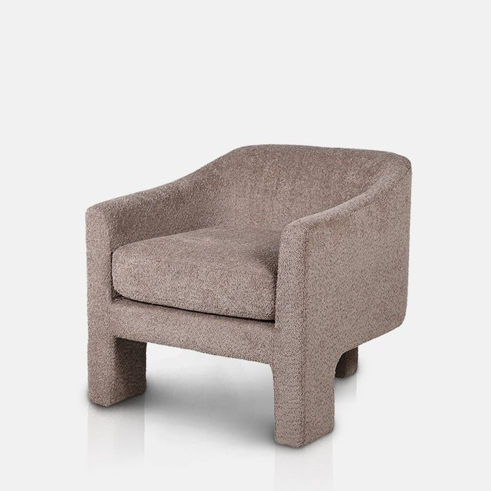 Abigail Ahern Ingram Grey Boucle Armchair in soft grey boucle, featuring a rounded tub-style seat, low curved backrest and distinctive three-legged base with a contemporary sculptural silhouette.