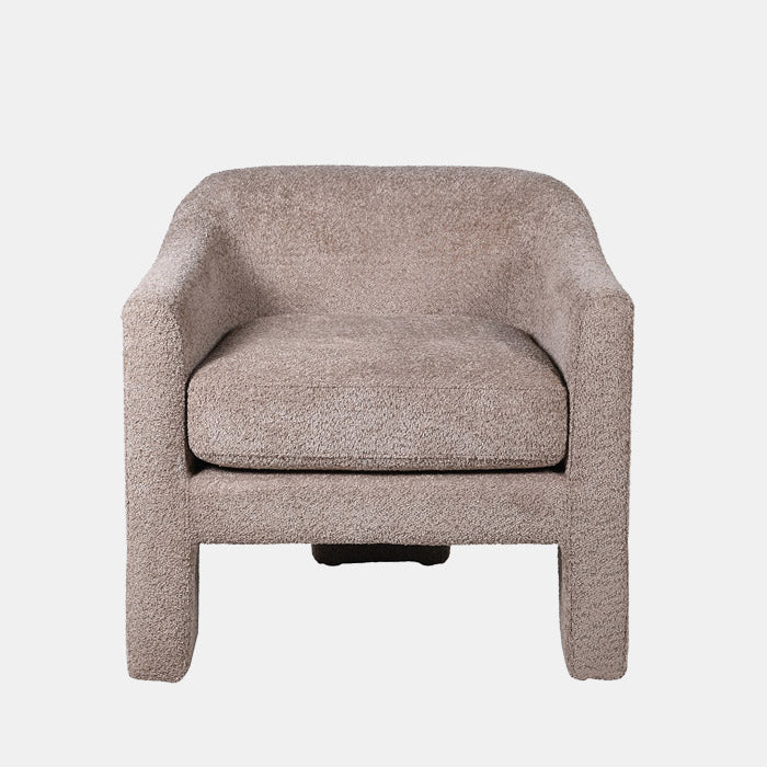 Abigail Ahern Ingram Grey Boucle Armchair in soft grey boucle upholstery, featuring a low curved back, rounded tub-style silhouette and distinctive three-legged base, styled as a contemporary statement chair in a sophisticated interior.