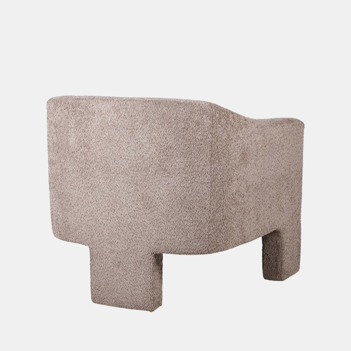 Abigail Ahern Ingram natural Boucle Armchair in plush grey boucle fabric, showcasing its generously rounded seat, low backrest and sculptural three-legged design, adding texture and contemporary character to a modern interior.