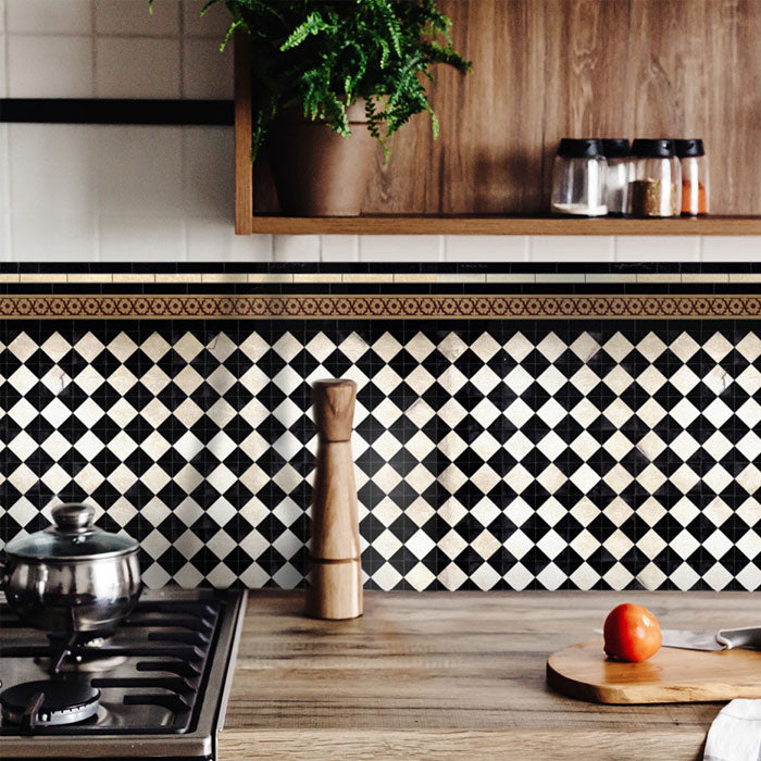Black and white tiled patterned vinyl backsplash stickers along the back of a kitchen counter