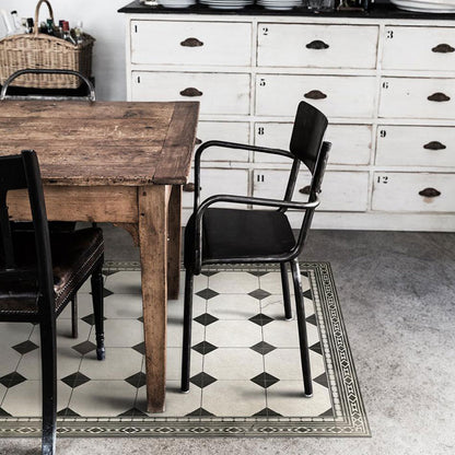 Black and white tiled pattern on a vinyl rug lying underneath a dining table and set of chairs