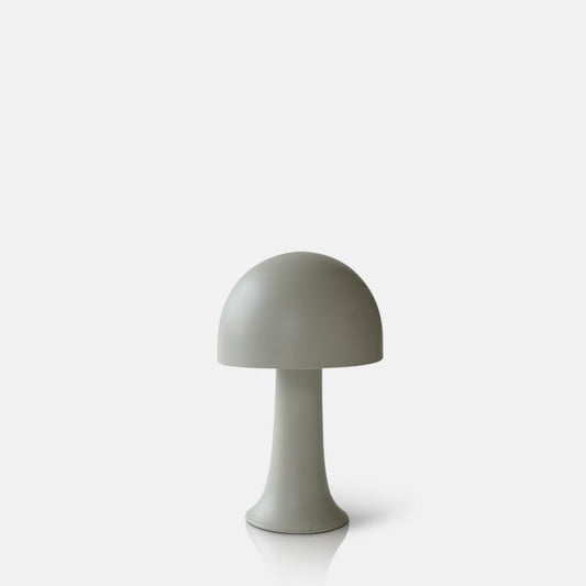 Cutout of a small metal curvaceaous mushroom shaped lamp in a light neutral colour by Abigail Ahern, known for her rule breaking designs and stylish interiors. Styled on a coffee table with some books, a houseplant,and a sculpture these small but mighty curvy lamps are super flexible to pop all over the house, style next to your bath, bedside or create intrigue to your tablescapes and a dash of colour to your kitchen worktops.