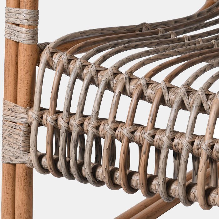A closeup of the woven rattan detail of the Kemble Rattan Occasional Chair.