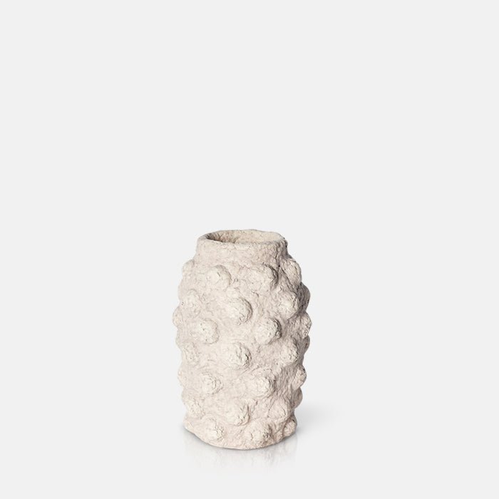 Cutout image on a white background of a textured beige cement vase with a bobble texture.
