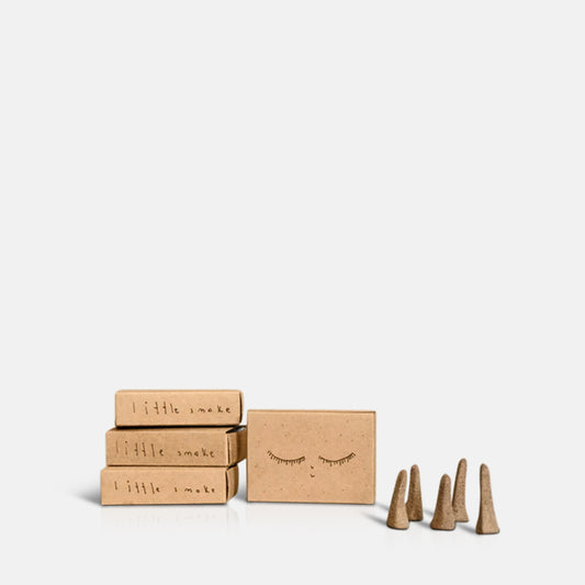 Five cone shaped incense next to for brown packaging boxes