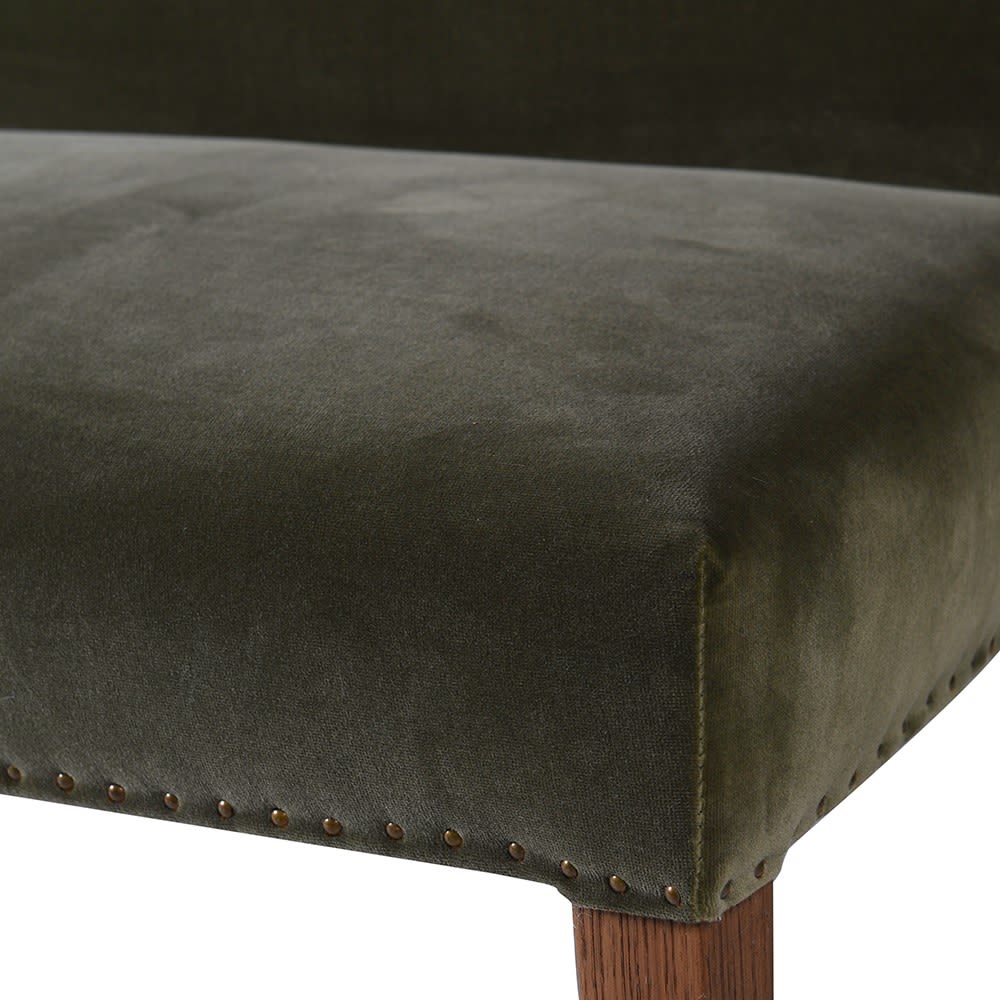 Close-up of the Abigail Ahern Thorne Velvet Dining Bench showcasing the soft, tactile velvet upholstery and natural grain of the solid oak wood frame.