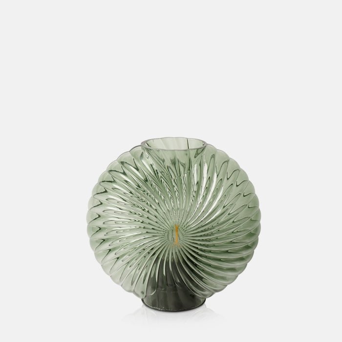 Cutout image of a green, shell shaped portable lamp.