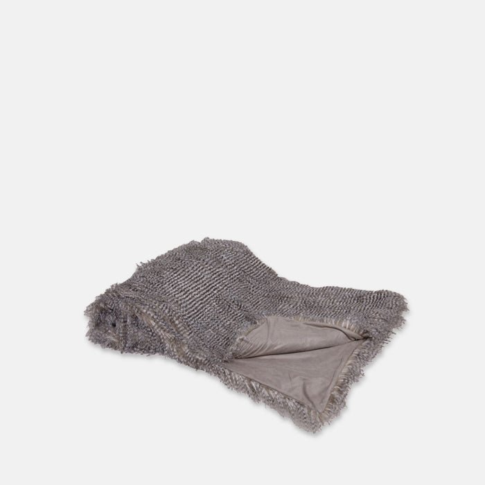 A cutout of the Malton Throw, a silvery faux fur throw with a thin black stripe.