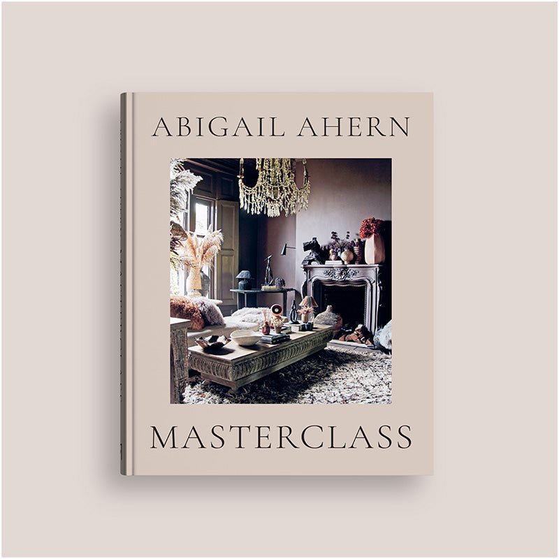 Masterclass, an A4 sized hardback book in a neutral tone with a front picture of a cosy lounge room in maximalist style.