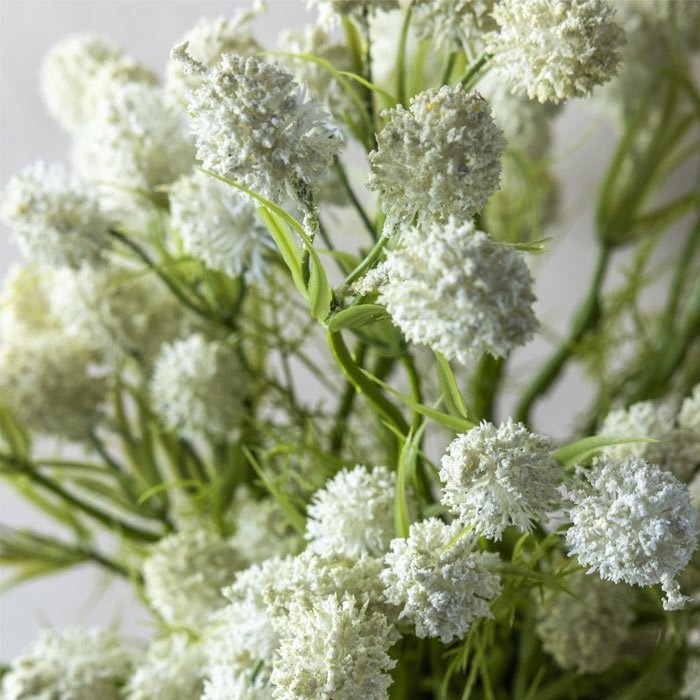 Detail image of artificial meadow thistle bush's round white floral heads.