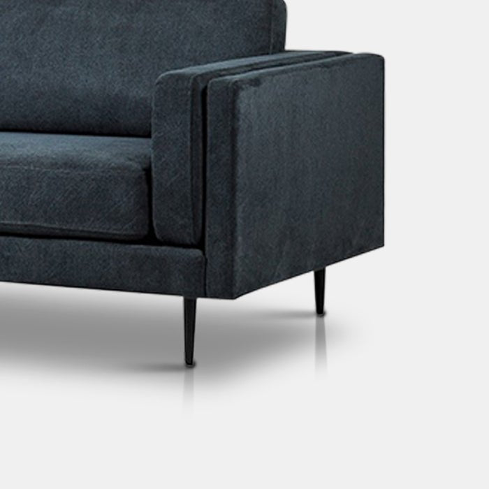  A closeup of the inky blue velvet fabric of the Medford 3 Seater Sofa.