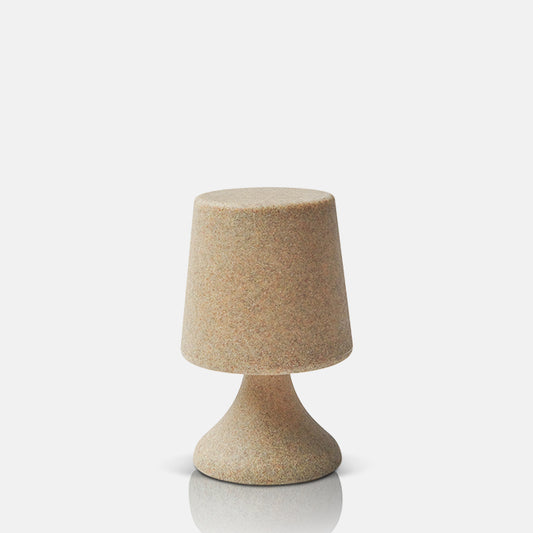 Wireless LED table lamp, in simple design crafted from sandy-toned plastic.