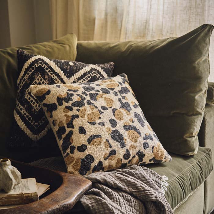 Patterned cushion in a camouflage style animal print in earthy colours on a neutral background. Adds style to your sofa or extra comfortable to your bed. 