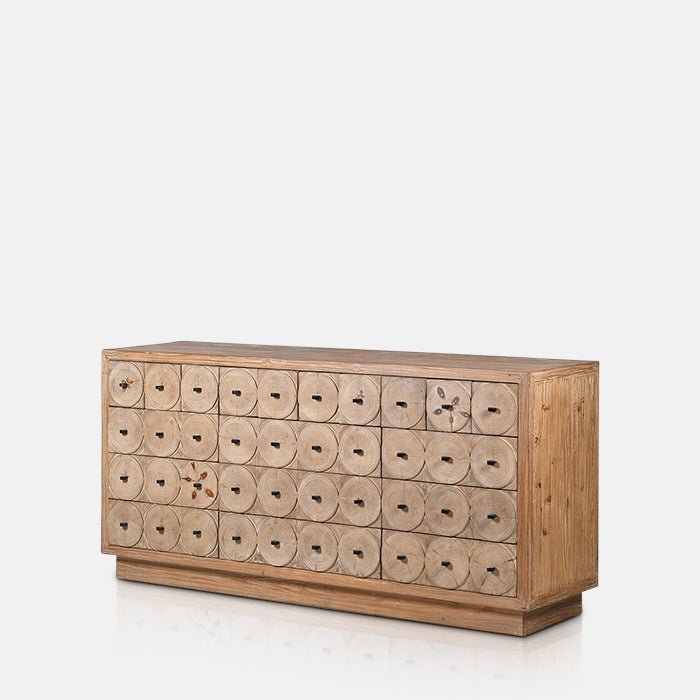 Large wooden Myton Sideboard with a circular pattern across it's drawers and black hardware. Reclaimed pine wooden sideboard with a textured natural finish, decorative circular detailing and statement black handles. Myton Wooden Sideboard by Abigail Ahern, 