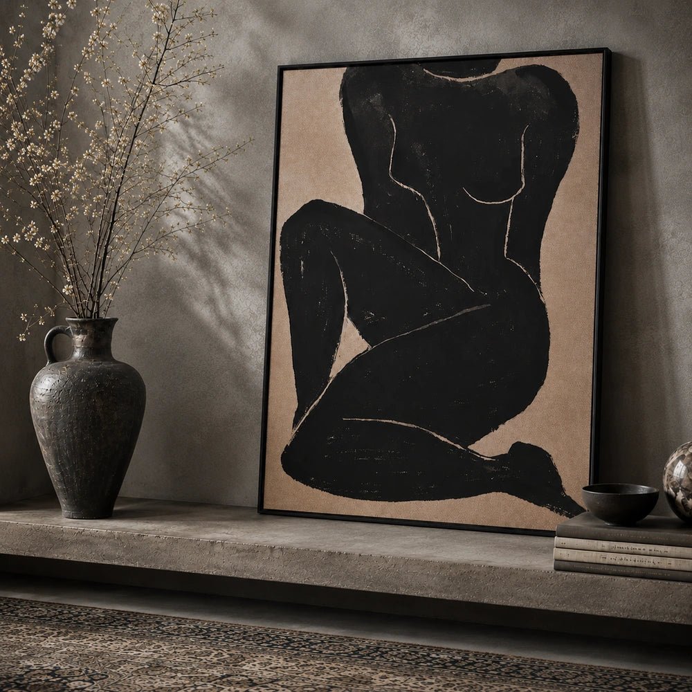 Namora Canvas Print displayed above a dark console table, with expressive neutral portrait artwork styled alongside sculptural vessels, dried foliage and stacked books.