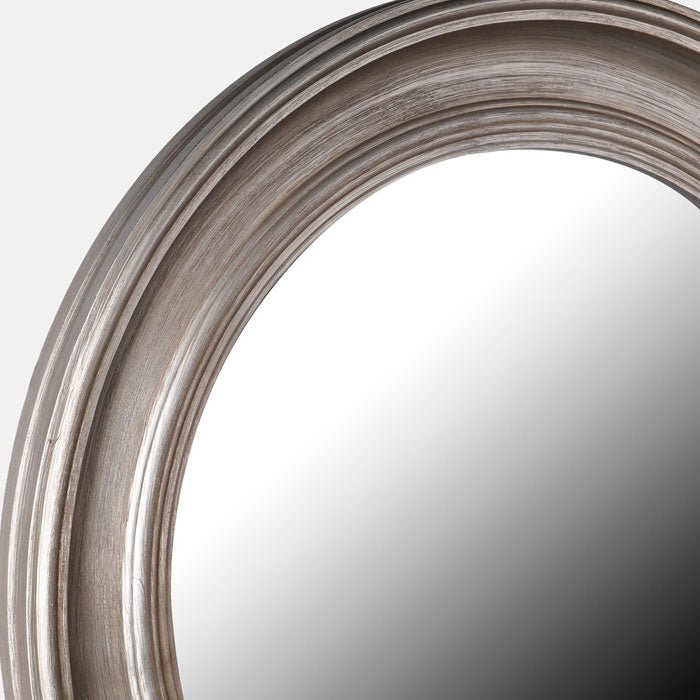 Chunky wooden frame with undulating curves around a round mirror