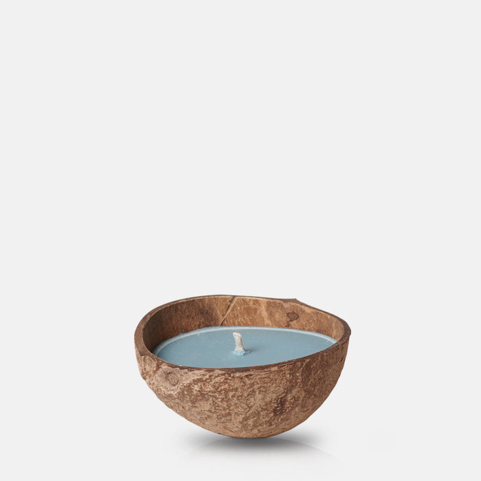 Blue coloured scented candle in a coconut shell holder