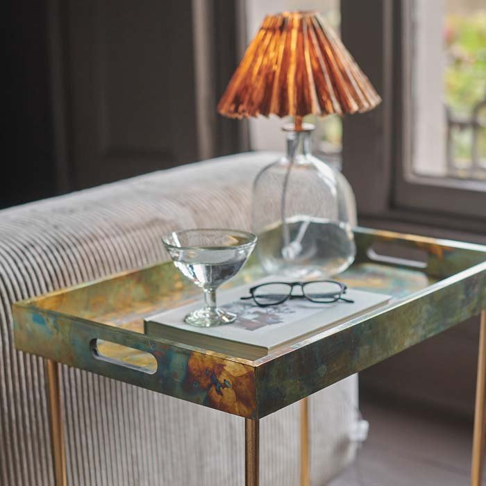 Rectangular side table with cutout handle design, in antique metallic patina.