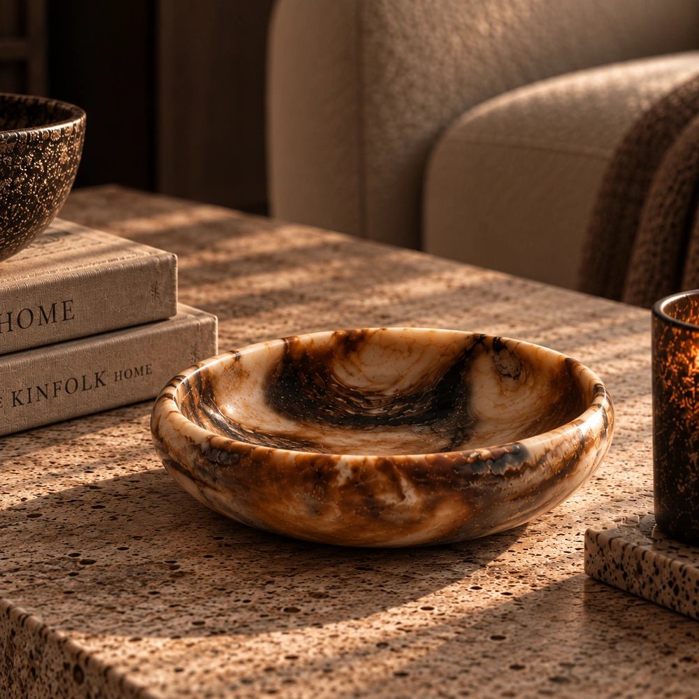 Omar Decorative Bowl shown close up in a warm neutral setting, highlighting its rounded sculptural silhouette, earthy brown colouring and richly textured decorative surface.