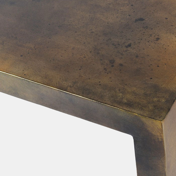 angular shape and aged gold finish of a console table