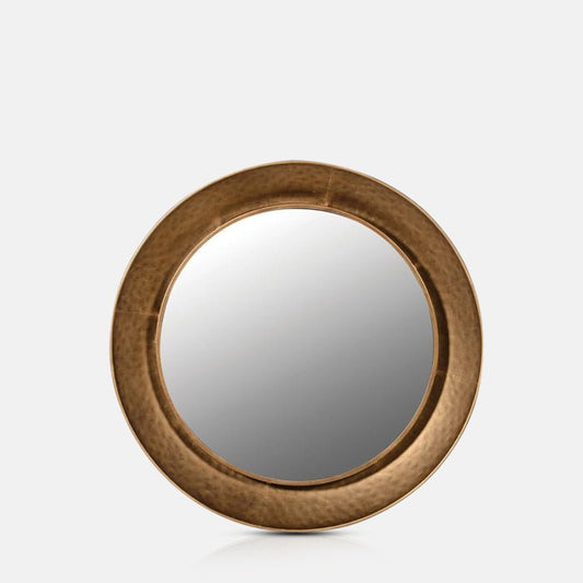 Large, round mirror with a chunky golden frame and hammered details