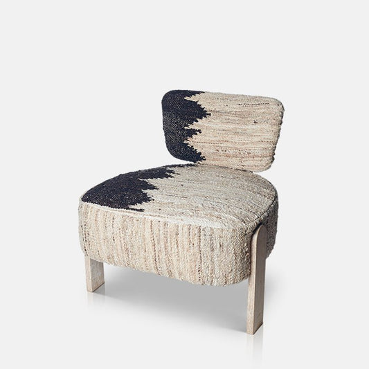 Cutout image on a white background of a woven, cream wool chair with a modern design and no arms. Sitting on three pale wooden legs, this contemporary accent chair has a geometric print that runs over the seat and back.