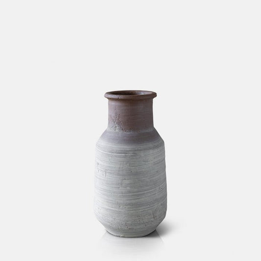 Cutout image on a white background of a classic stoneware vase with a brown to white ombre effect.