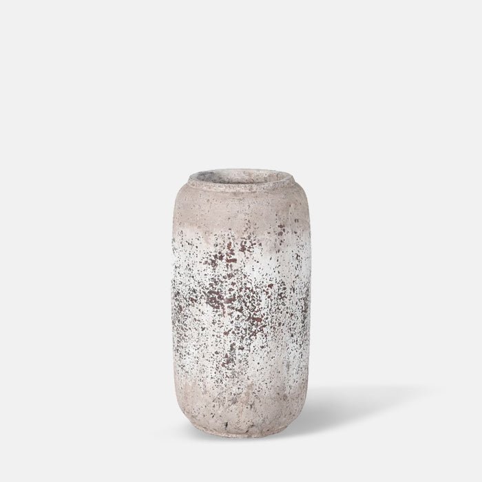A cutout of the Puerto Vase, a tall cylindrical distressed grey terracotta vase.