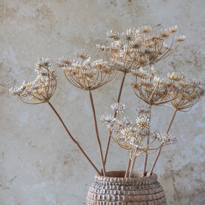 Close image of the premium artificial flowers from bestselling homeware brand Abigail Ahern, styled in a textured ceramic vase.