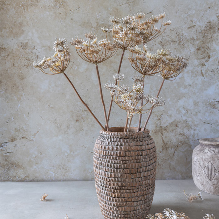 Several stems of premium artificial queen anne's lace in a cream and straw coloured hue, styled in a textured ceramic vase.