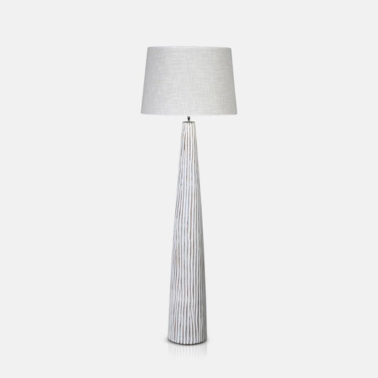 Tall white floor lamp with a ribbed texture base and linen shade