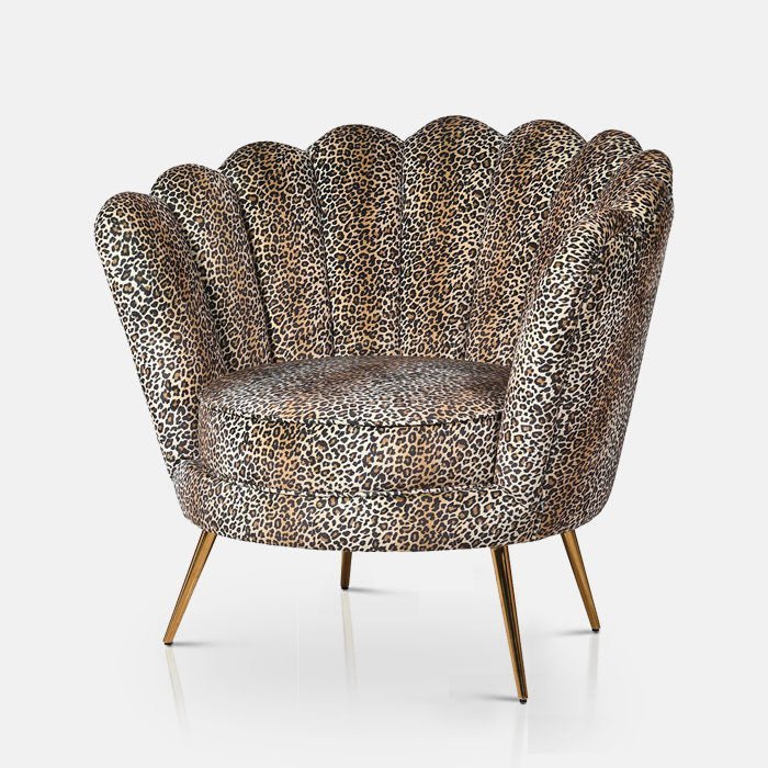 The Reno Leopard Print Armchair, a unique shell-shaped boudoir chair in leopard print with slim gold legs.
