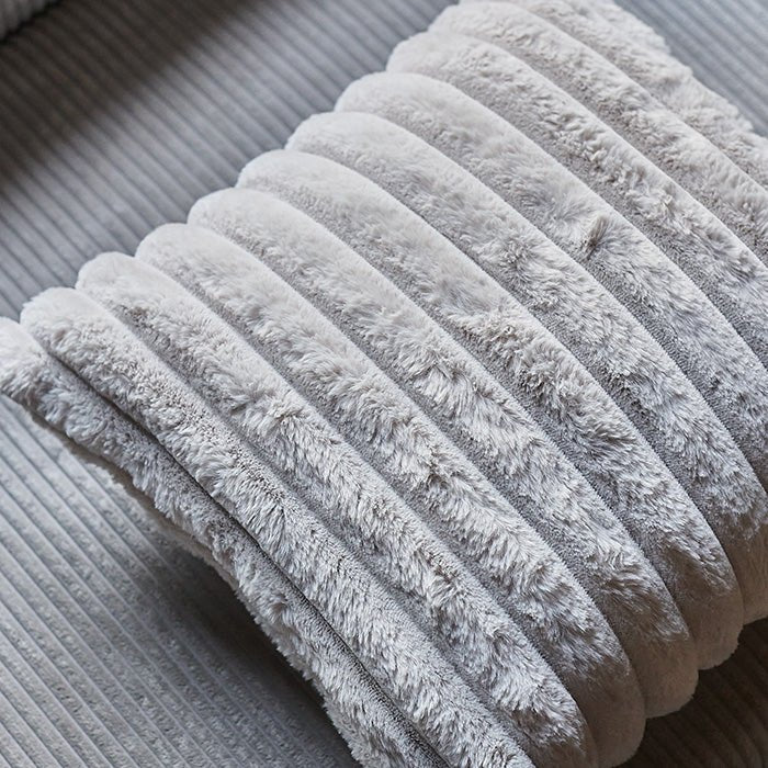 A closeup of the Reva Faux Fur Cushion, showing the rudged stitching detail.