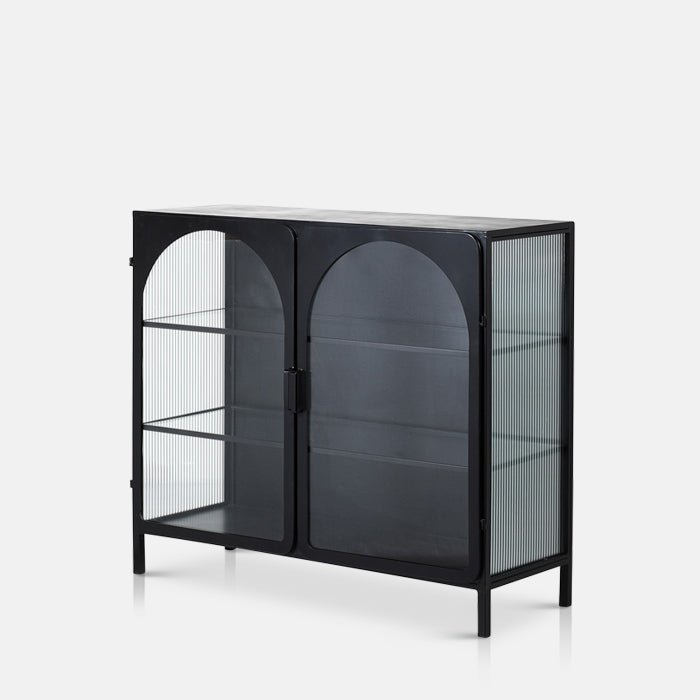 Black cabinet with arched glass doors and ribbing on its side