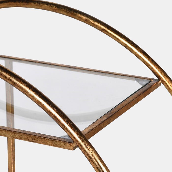 The Gold metal frame curved around clear glass shelves on the Rover Drinks Trolley.