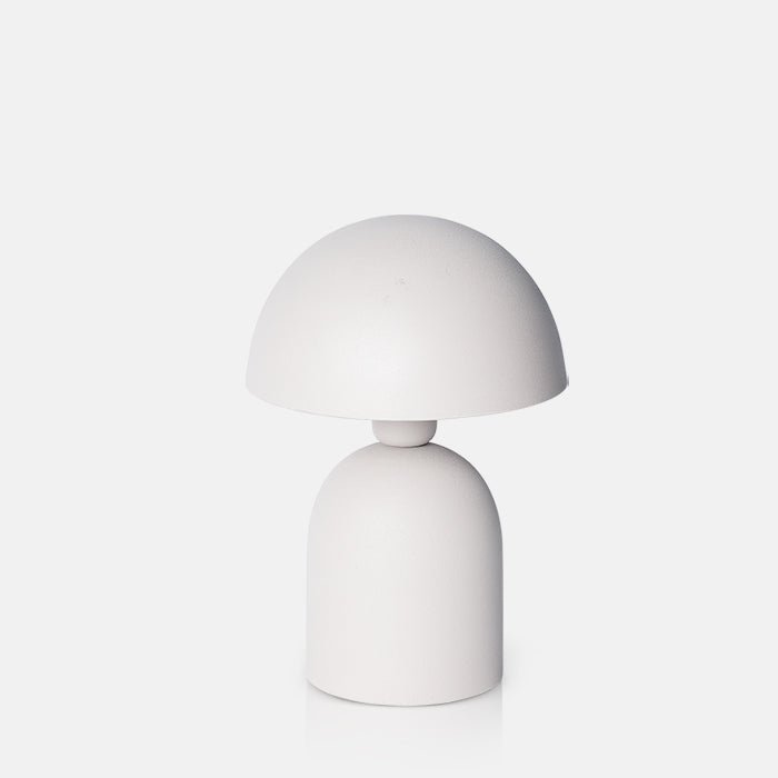 Cutout on a white background of a small pale grey table lamp with a round base and a matching curved, solid dome shade.