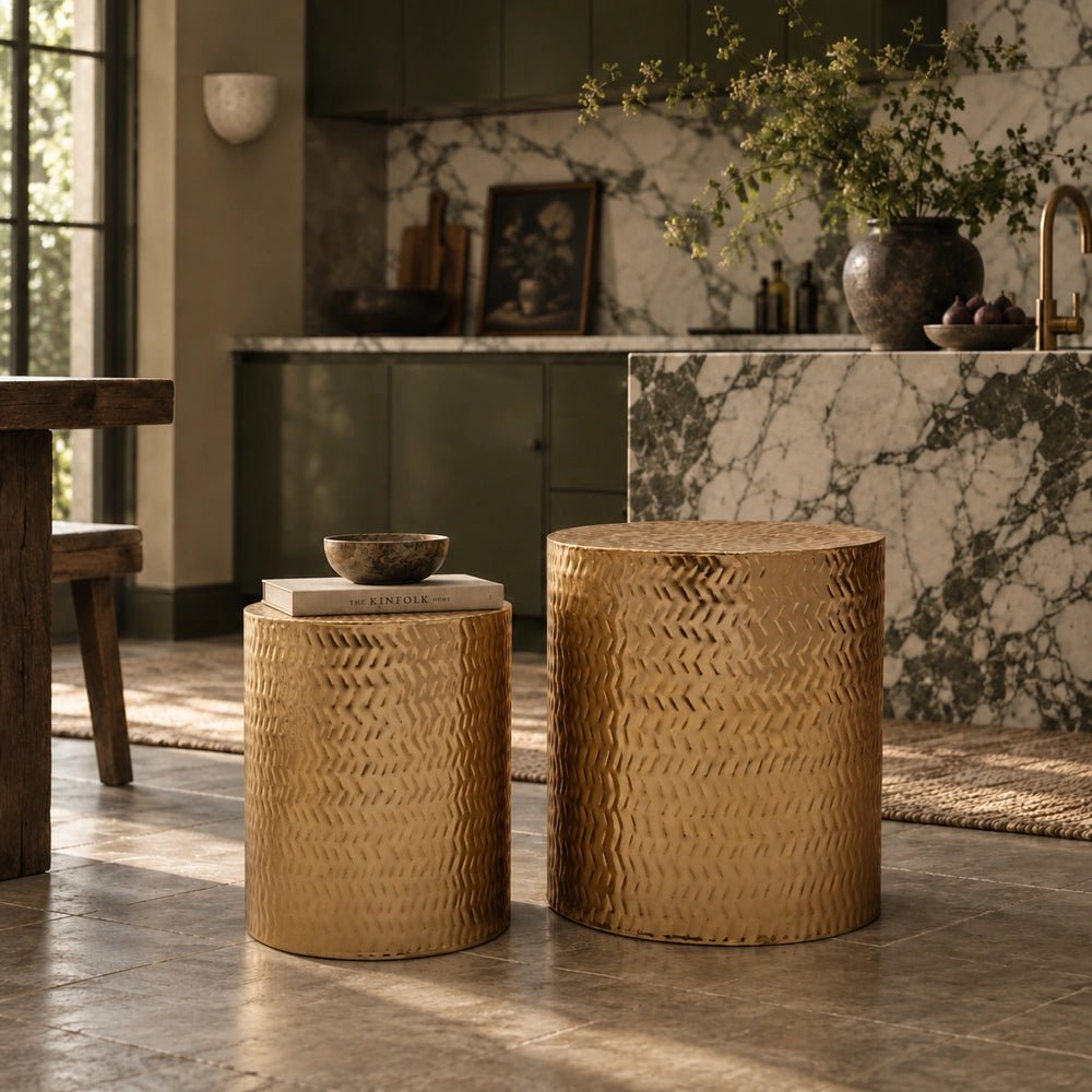 Salado Metal Side Tables with patterned gold surfaces styled as a pair in a warm living room with marble, foliage and neutral contemporary furnishings.