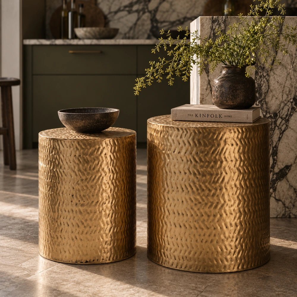 Salado Metal Side Tables with textured gold surfaces styled together in a warm living room beside marble, ceramics and softly layered contemporary furnishings.