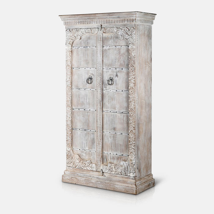 Aged look wooden cabinet with carved details around its edge and black hardwaare